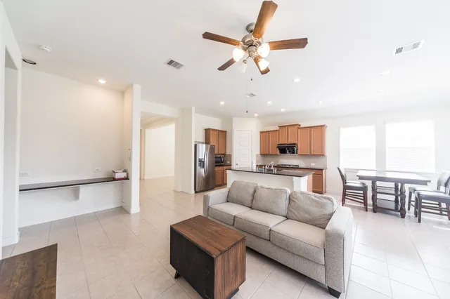 a living room with furniture and kitchen view