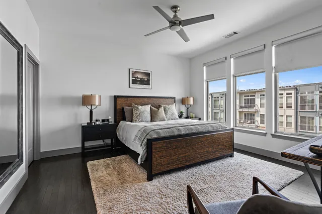 a bedroom with a bed couch and a window