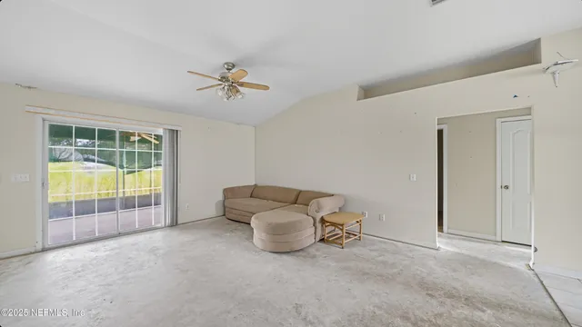 an empty room with furniture and windows