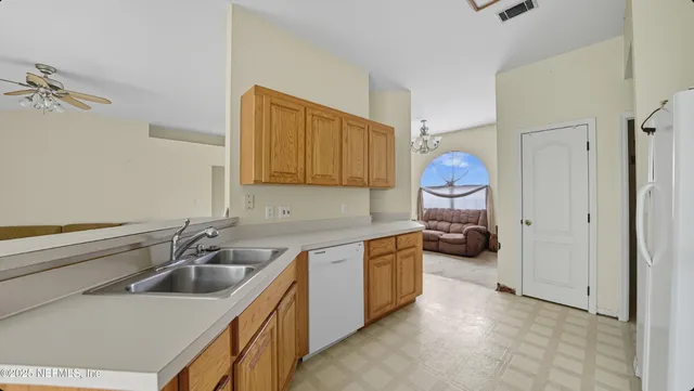 a kitchen that has a sink and a stove