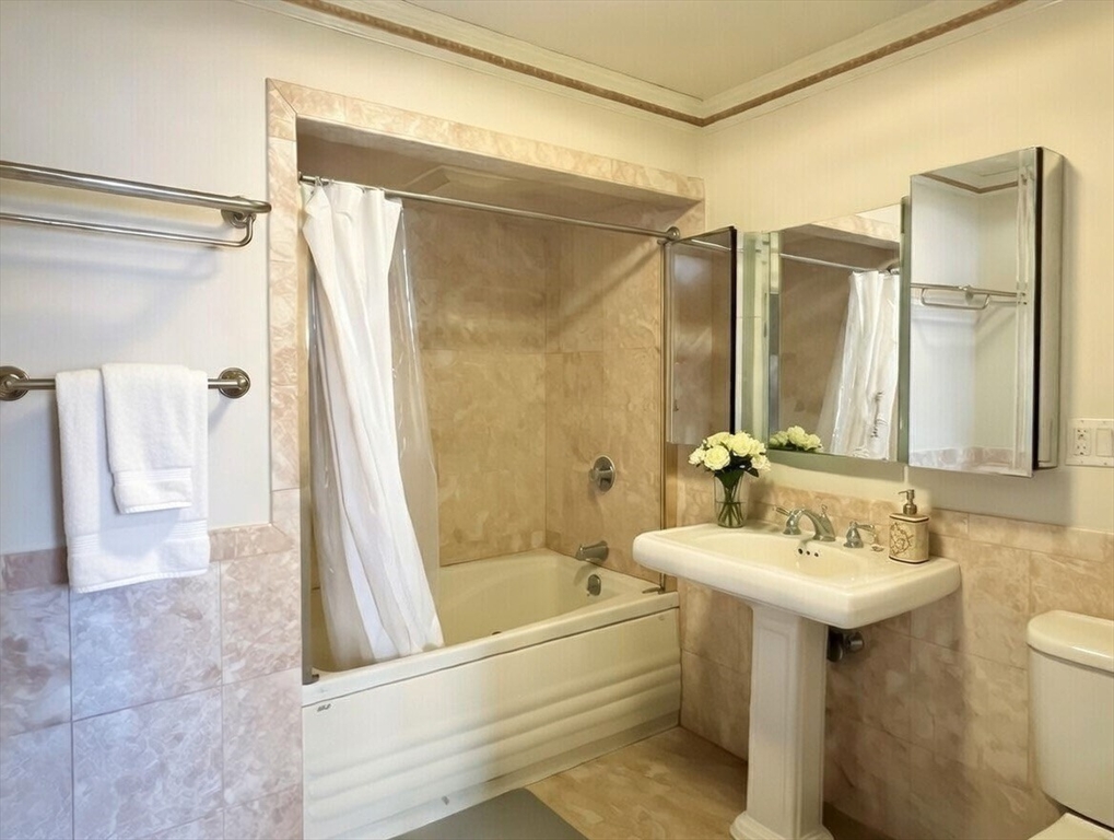 1002 Beacon Street Brookline, MA 02446 - Photo 15 of 17 a bathroom with a sink mirror toilet and bathtub