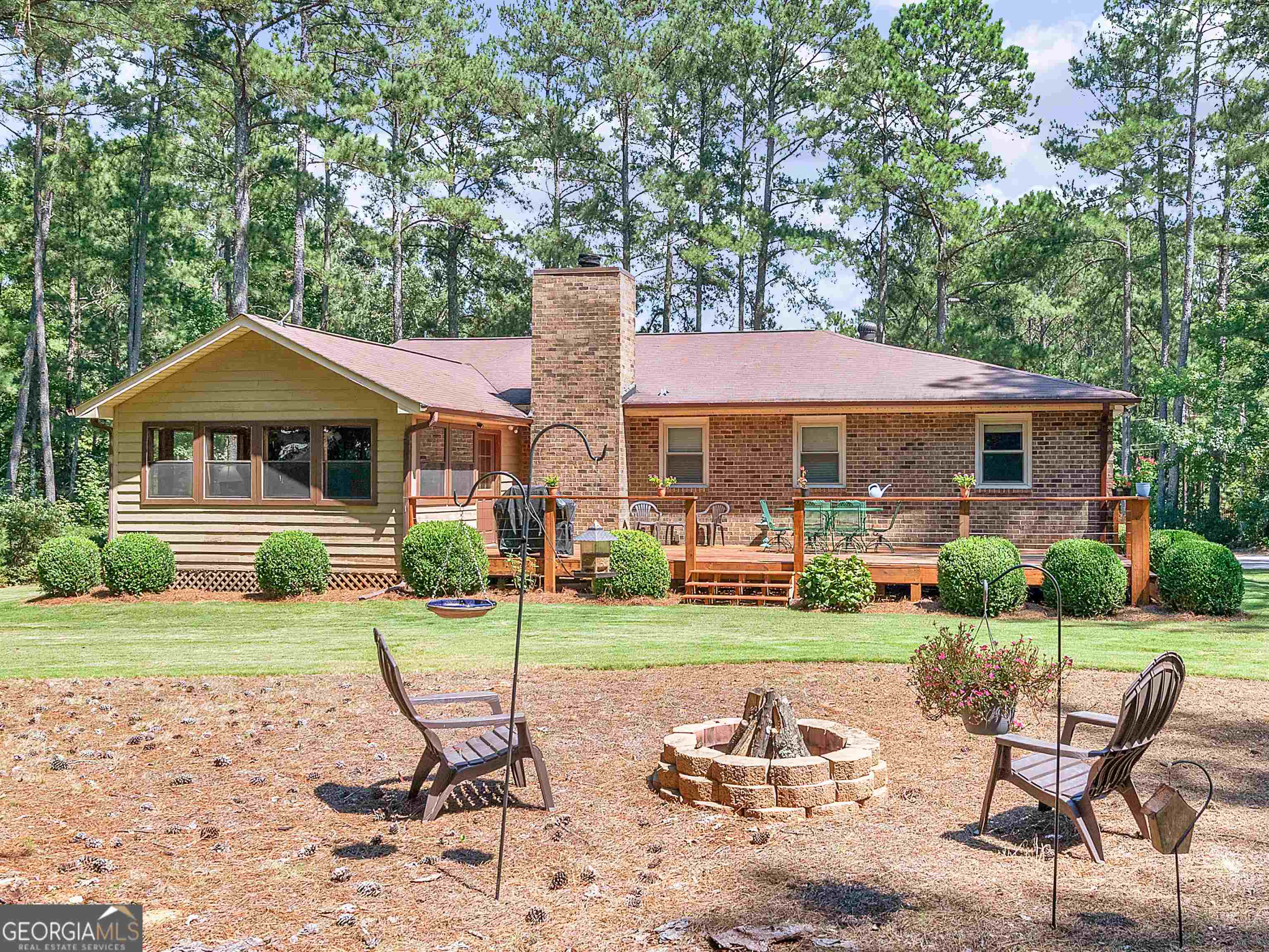 435 Rabbit Run McDonough, GA 30252 - Photo 1 of 1 a patio with a table and chairs under an umbrella