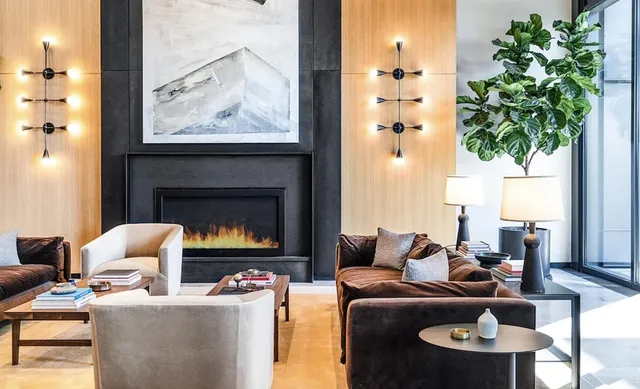 a living room with furniture a chandelier and a fireplace