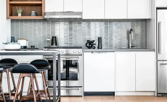 a kitchen with stainless steel appliances kitchen island wooden cabinets