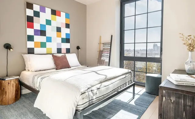 a bedroom with a bed and a window