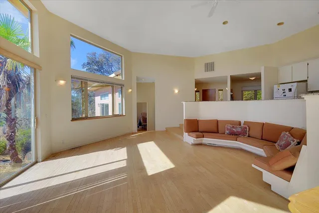 a kitchen with granite countertop a stove and a wooden floor