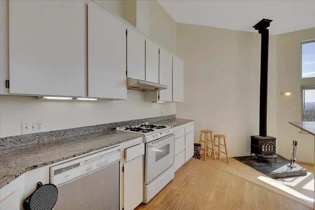 a bedroom with a bed couch and a large window