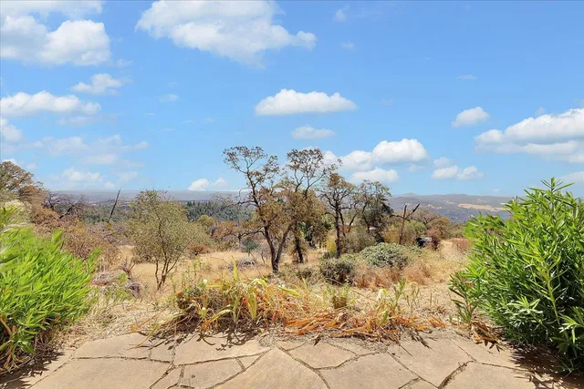 a backyard of a house with table and chairs
