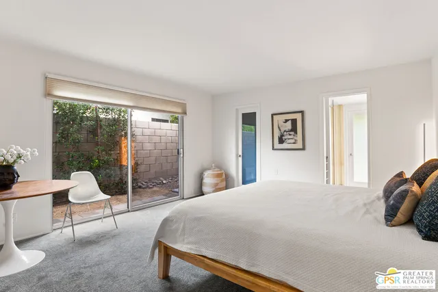 a bedroom with a bed and large window