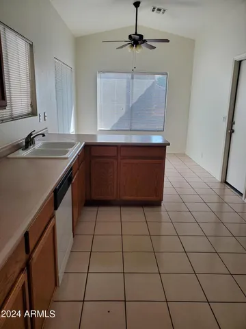 a kitchen with a sink a counter space and cabinets