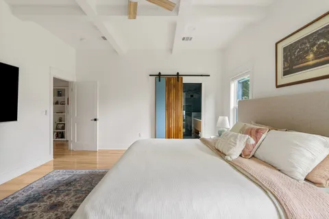a bedroom with a bed and walk in closet