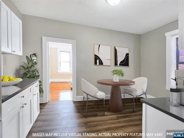 a kitchen with granite countertop a stove a sink and a microwave