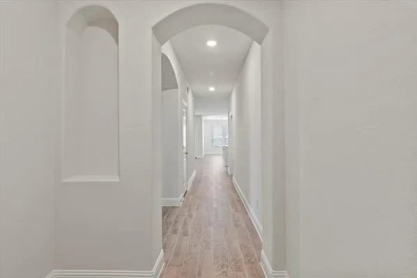 a view of a hallway with wooden floor