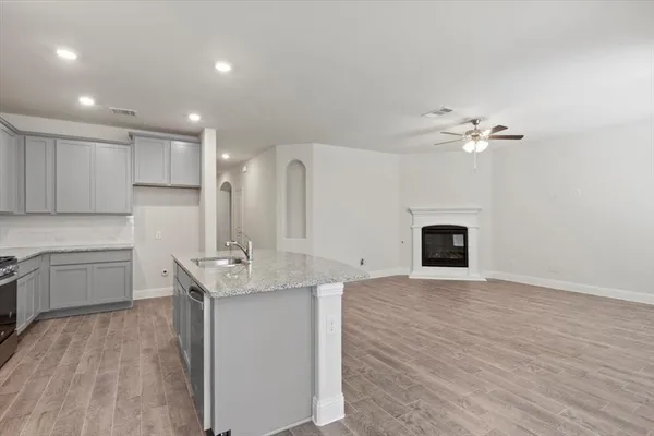 a kitchen with kitchen island a sink stainless steel appliances and cabinets