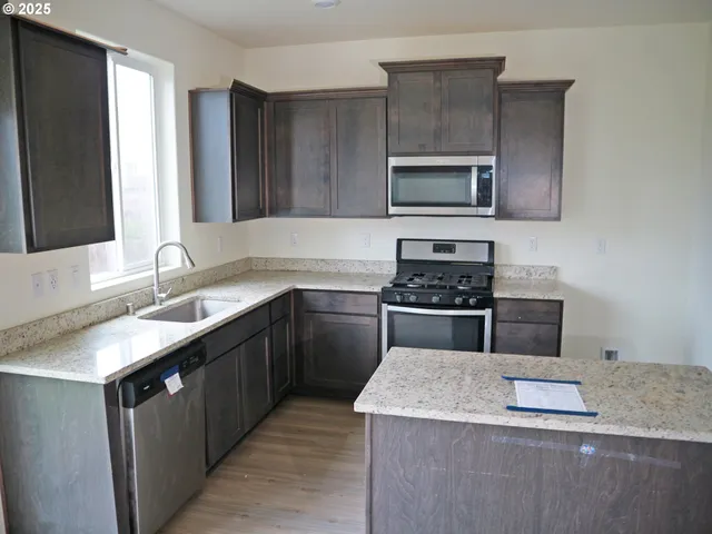 a kitchen with a sink stove and microwave