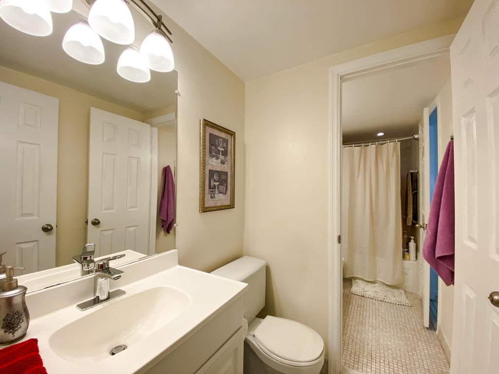 935 Flanders T Delray Beach, FL 33484 - Photo 6 of 13 Half Bathroom & Full Bathroom Door