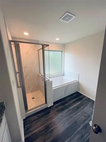 a bathroom with a bathtub and a window