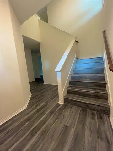 a view of kitchen and hall with wooden floor