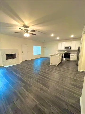 a view of kitchen with cabinets and wooden floor