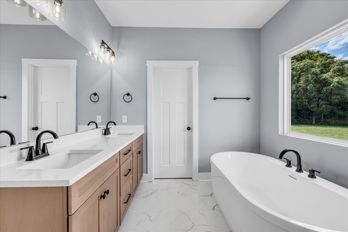 25 Lookout Drive Winchester, TN 37398 - Photo 36 of 61 a bathroom with a double vanity sink a mirror and a bathtub