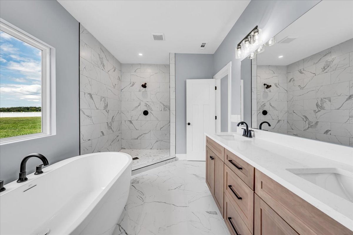 25 Lookout Drive Winchester, TN 37398 - Photo 39 of 61 a bathroom with a double vanity sink a mirror a bathtub and shower