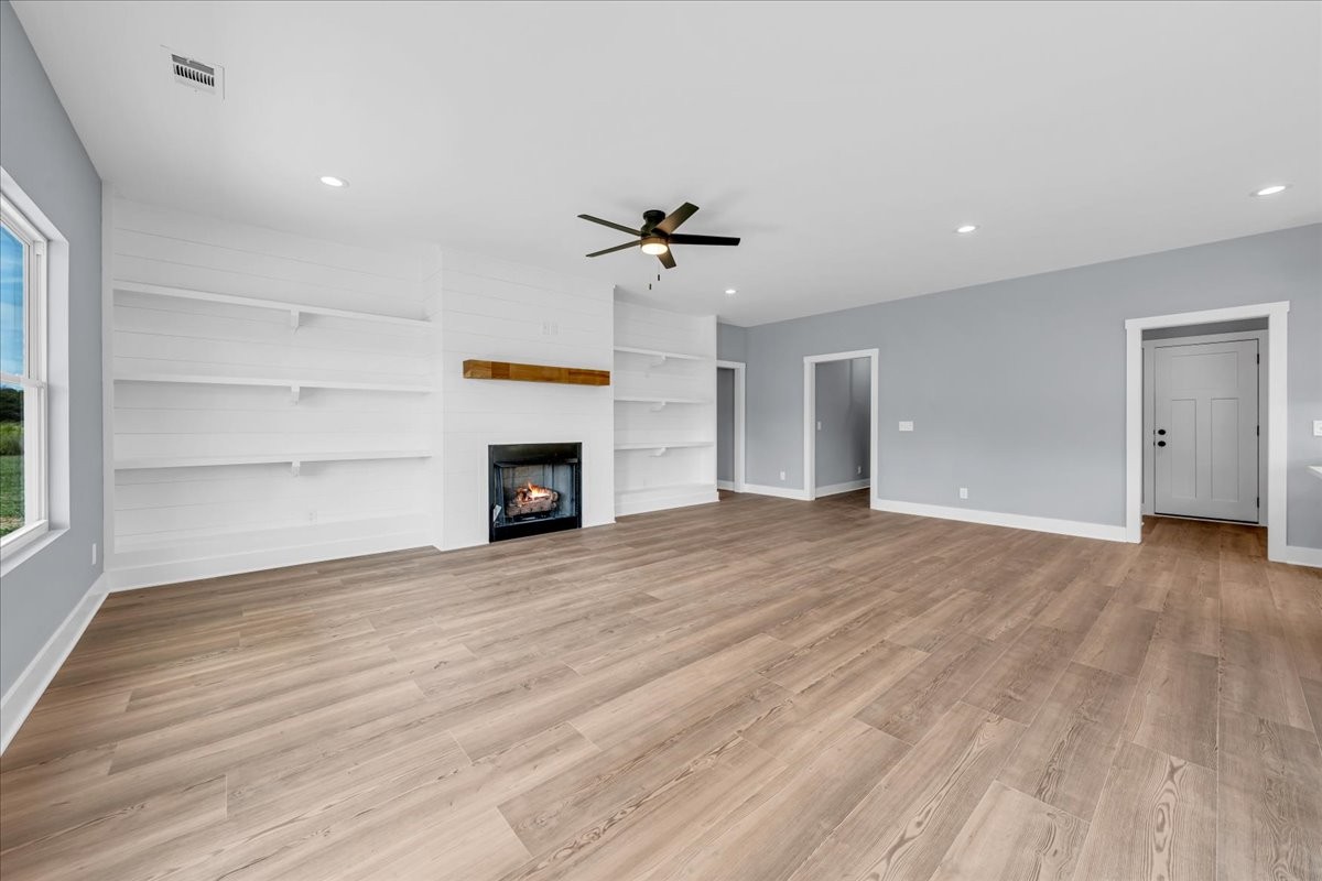 25 Lookout Drive Winchester, TN 37398 - Photo 9 of 61 wooden floor in an empty room with a fireplace
