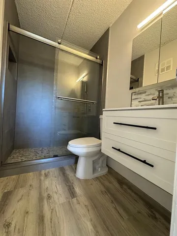 a bathroom with a sink toilet and shower