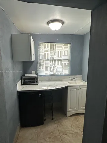 a kitchen with a sink cabinets and window