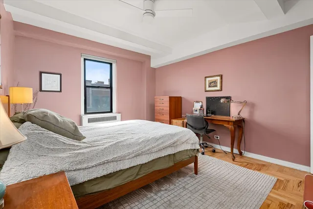 a bedroom with a bed a dresser and chair