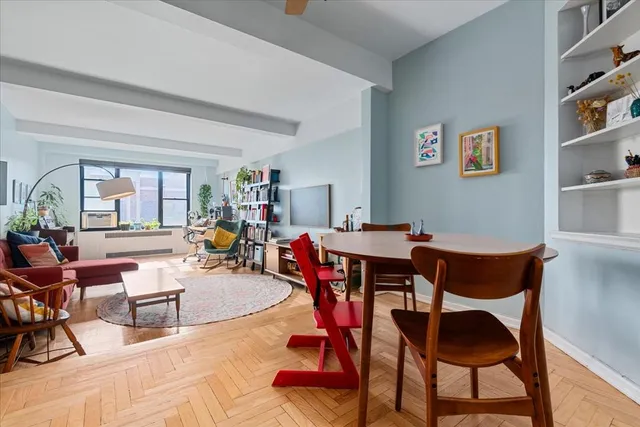 a living room with furniture a rug and a table