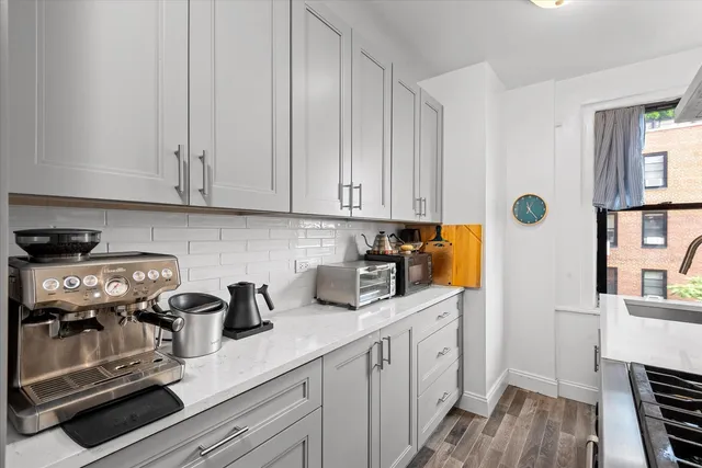 a white stove top oven sitting inside of a kitchen