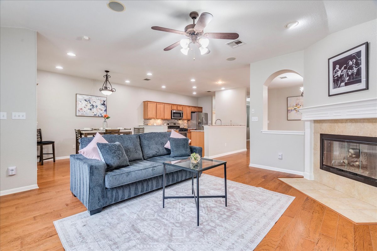 1151 Stone Rim Loop Buda, TX 78610 - Photo 4 of 35 This living space features warm hardwood floors, an inviting fireplace