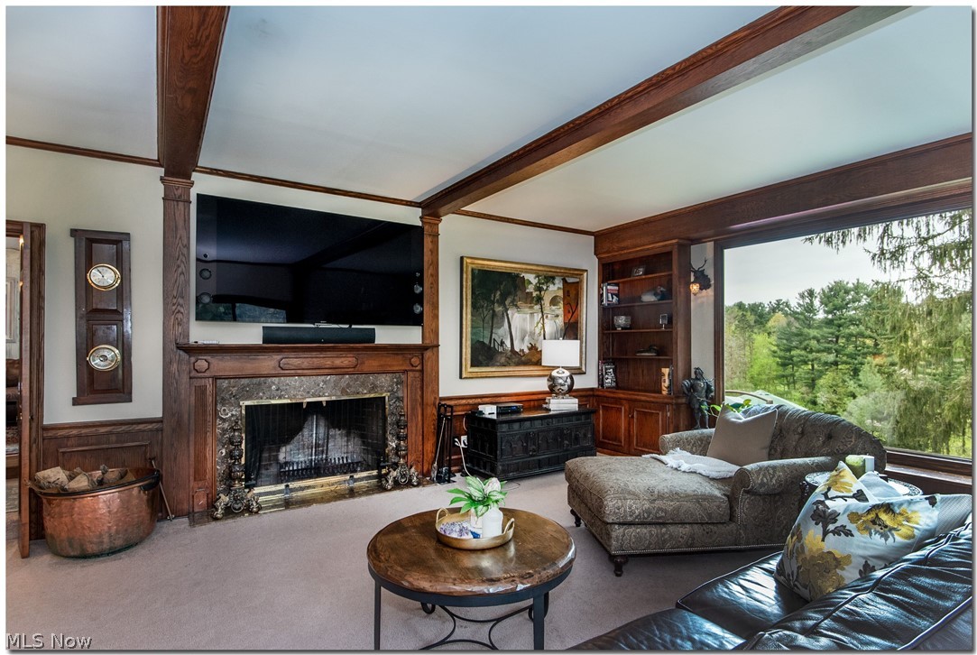 33955 Old Kinsman Road Hunting Valley, OH 44022 - Photo 7 of 35 The wood-accented family room has an oversized fireplace and a view of the back yard and pool that will take your breath away.