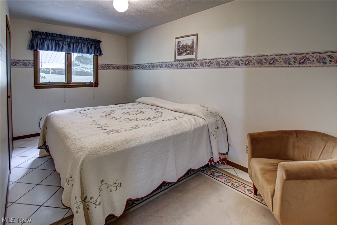 6013 Rousseau Drive Parma, OH 44129 - Photo 12 of 50 Tiled bedroom featuring a textured ceiling