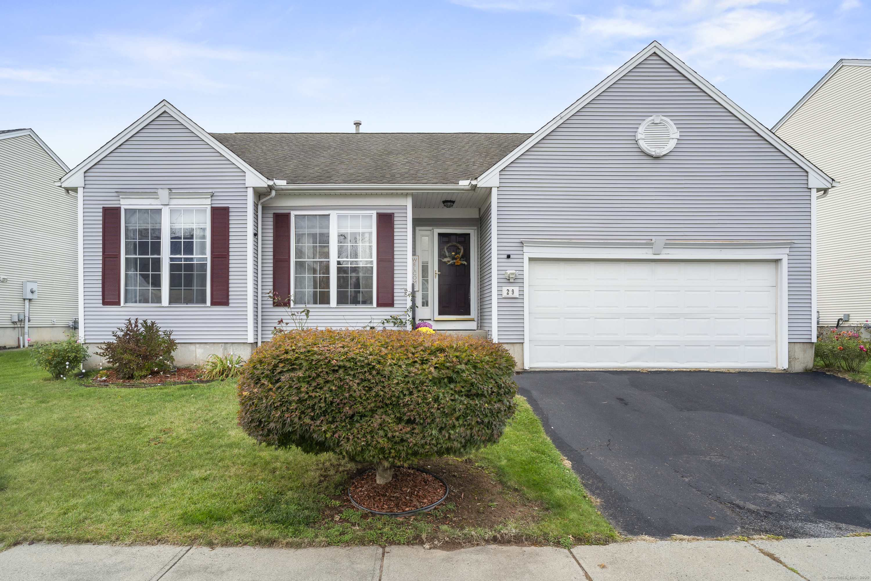 29 Primrose Lane, Unit 29 Suffield, CT 06078 - Photo 1 of 1 Charming front view of 29 Primrose Lane, showcasing classic curb appeal and a beautifully maintained landscape.