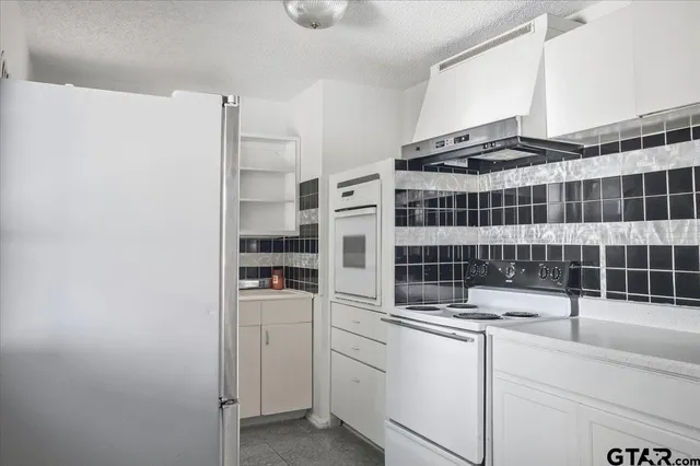 a kitchen with a refrigerator and a sink