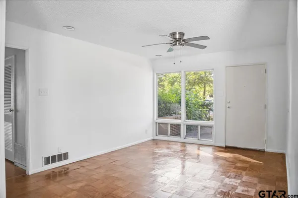 a view of an empty room with a window