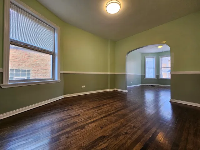 a view of a room with wooden floor and a window