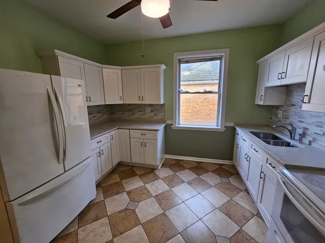 a kitchen with stainless steel appliances a stove a sink and a refrigerator