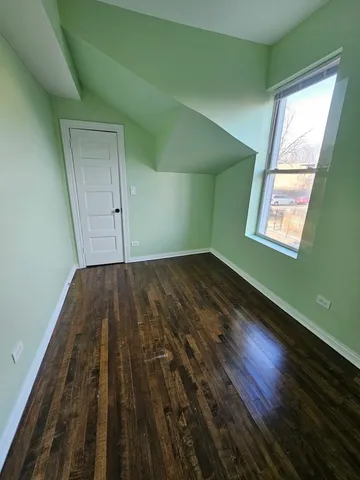 a view of a room with wooden floor and windows