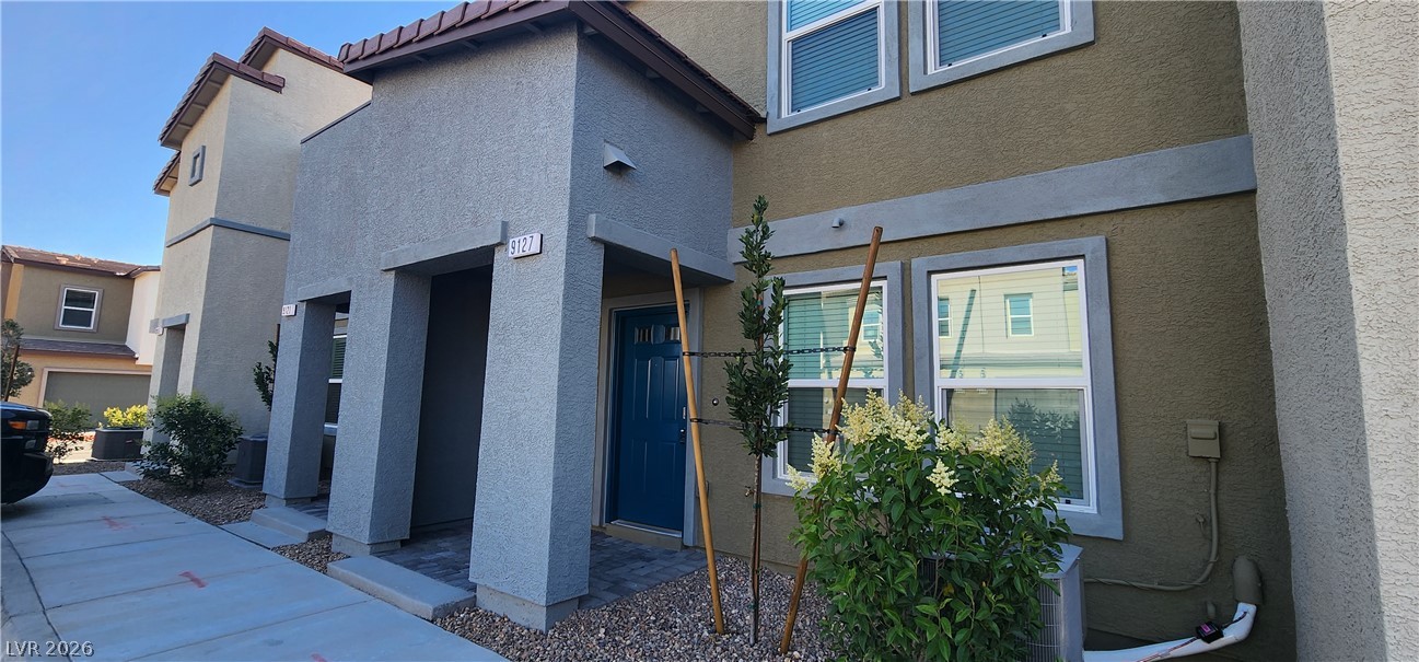 9127 Rory Storm Street Las Vegas, NV 89113 - Photo 27 of 27 A classic stucco exterior pairs with clean lines and a private recessed entryway.