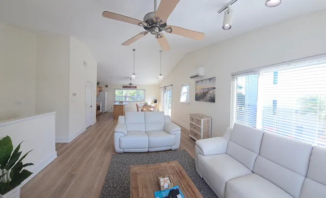 a dining room with furniture a chandelier and wooden floor