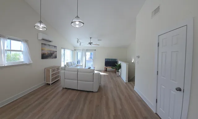 a balcony with view of potted plants and palm trees