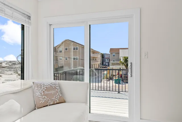 a dining room with furniture a chandelier and wooden floor