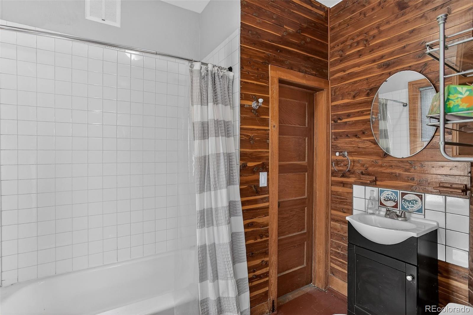 1902 Grove Street Boulder, CO 80302 - Photo 19 of 38 a bathroom with a sink a mirror and shower