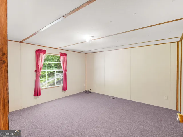 an empty room with windows and entrance