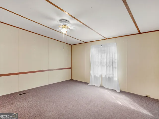 a view of an empty room with a mirror