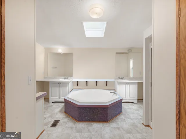 a bathroom with a sink a mirror and a bathtub