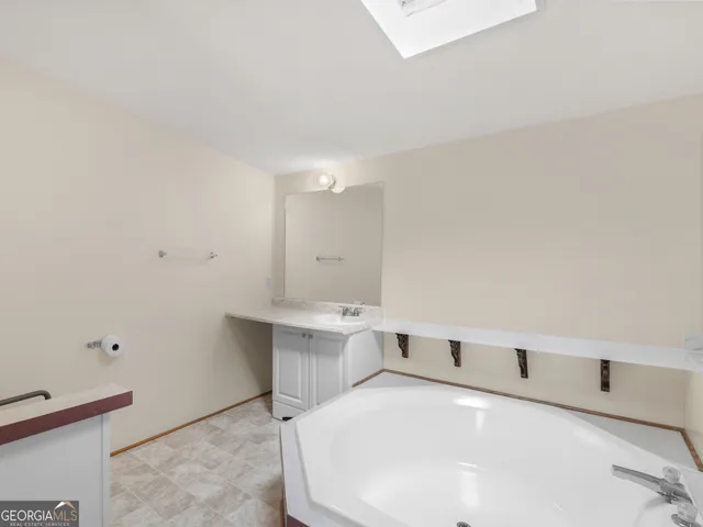 a bedroom with a bed and a sink