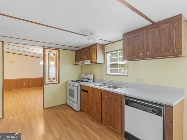 a kitchen with a stove a sink and a refrigerator